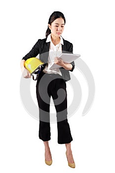 Woman engineer holding a yellow helmet and reading construction documents on white background