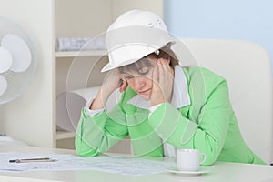 Woman - engineer in protective helmet on workplace
