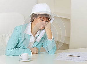 Woman engineer sits on workplace at office