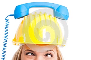 Woman engineer with telephone receiver on hat looking crosswise photo