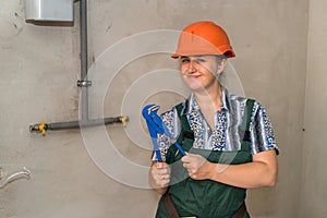 Woman engineer with tool belt and adjustable key