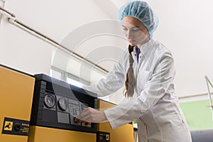 Woman engineer writing observations about equipment and production photo