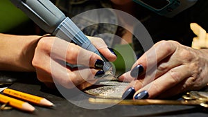 Woman engraver at work.