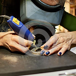 Woman engraver at work.