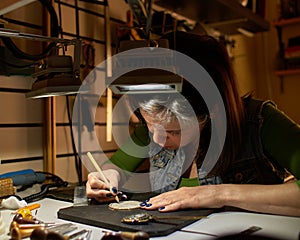 Woman engraver at work.