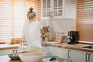 Woman enjoy cooking simple noodle in the kitchen as a hobby.