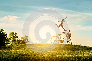 Woman enjoy holiday in the park. She was jumping with happiness photo