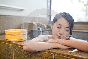 Woman enjoy hot springs in Japanese onsen photo