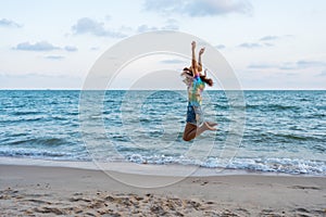 Woman enjoy and jumping on sea beach
