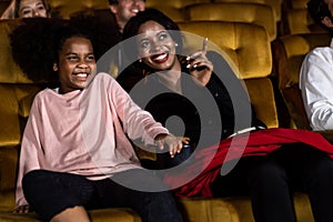 Woman enjoy to watch a movie with her daughter