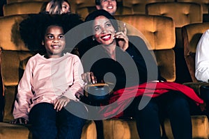 Woman enjoy to watch a movie with her daughter