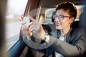 Woman enjoy on the traveling and taking photos from a car