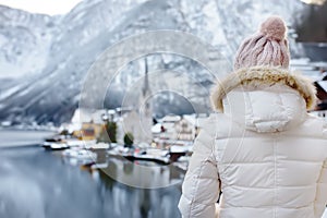 Woman enjoy winter scenic view of village of Hallstatt in the Austrian Alps