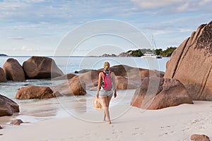 Woman enjoying Anse Lazio picture perfect beach on Praslin Island, Seychelles.
