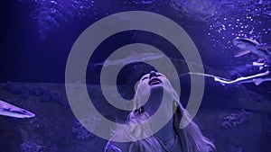 Woman enjoying aquarium view.