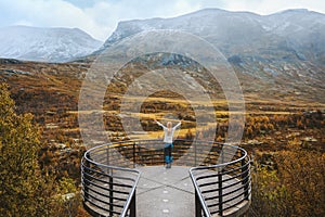 Woman enjoying autumn landscape on Vegaskjelet viewpoint travel outdoor aerial view forest and mountains