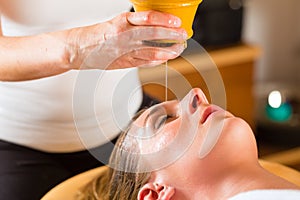 Woman enjoying a Ayurveda oil massage