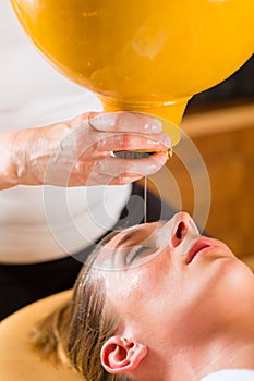 Woman enjoying a Ayurveda oil massage