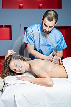 Woman enjoying during a back massage at a spa relax all body massage