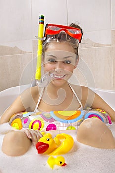 Woman is enjoying a bath in mask with snorkel.