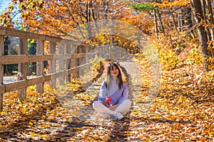 Woman enjoying the beautiful Fall Colors at Kancamagus Hwy in New Hampshire USA