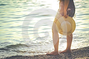 Woman enjoying the beautiful sunset on the beach.