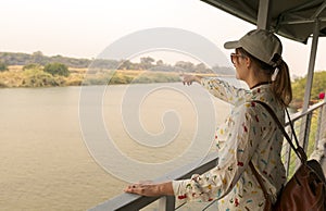 woman enjoying a beautiful view of the African savannah during a safari tour. Adventure and wildlife exploration in Africa