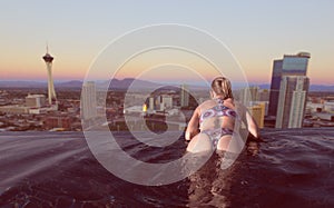 Woman enjoying the city view of Las Vegas from infinity pool