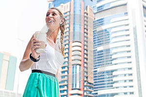 Woman enjoying coffee to go in metropolitan city