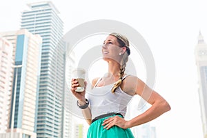 Woman enjoying coffee to go in metropolitan city