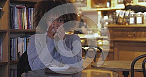 Woman enjoying cup of tea in cafe