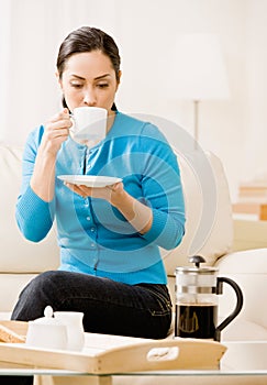 Woman enjoying drinking a cup of coffee