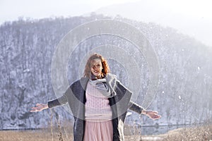 Woman enjoying the falling snow