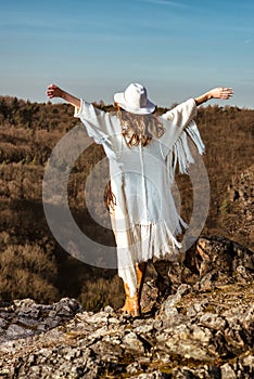 Woman enjoying the feeling of freedom walking in the mountains photo