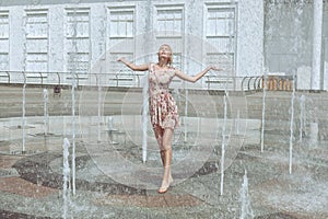 Woman is enjoying a fountain.