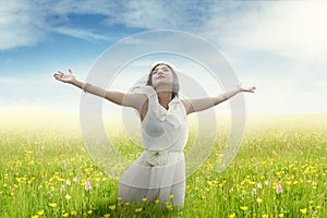 Woman enjoying freedom on flower field