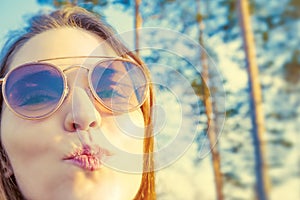 Woman tourist enjoying fresh air in the woods and sending air kiss photo