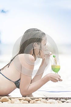 Woman enjoying a fresh cocktail in a pool