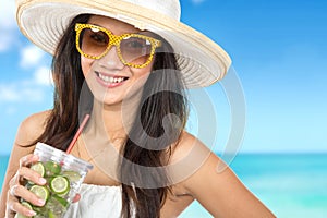 Woman enjoying fresh lime infuse water at the beach