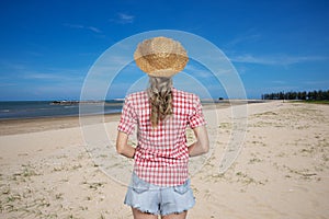 Woman enjoying freshness on beautiful view of beach and bright blue sky