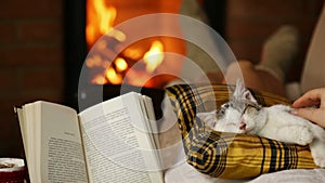 Woman enjoying a good book and the company of her kitten