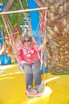 Woman enjoying hammock in Crete.