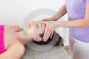 Woman enjoying head massage in Acupressure treatment Relaxation and Alternative medicine