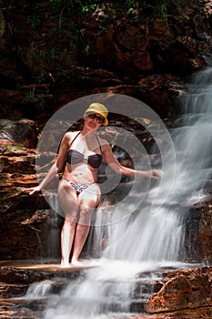 Woman enjoying herself at a waterfall