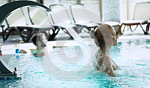 Woman enjoying hydrotherapy in spa pool