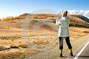 Woman Enjoying Landscape Of Autumn Mountains. Woman Hiker Taking Photo