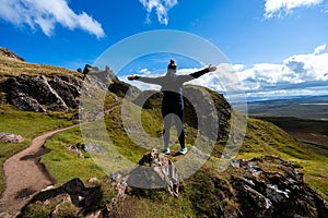 Woman enjoying the landscape at a hike on Ilse of Skye, Scotland