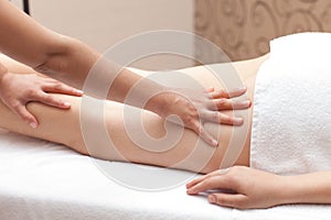 Woman enjoying a leg massage in a spa setting