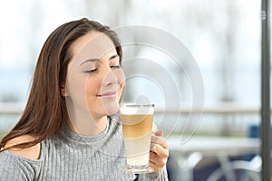 Woman enjoying a macchiato coffee photo