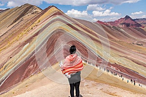 Woman enjoying the magnificient view of Rainbow Mountain Peru South America